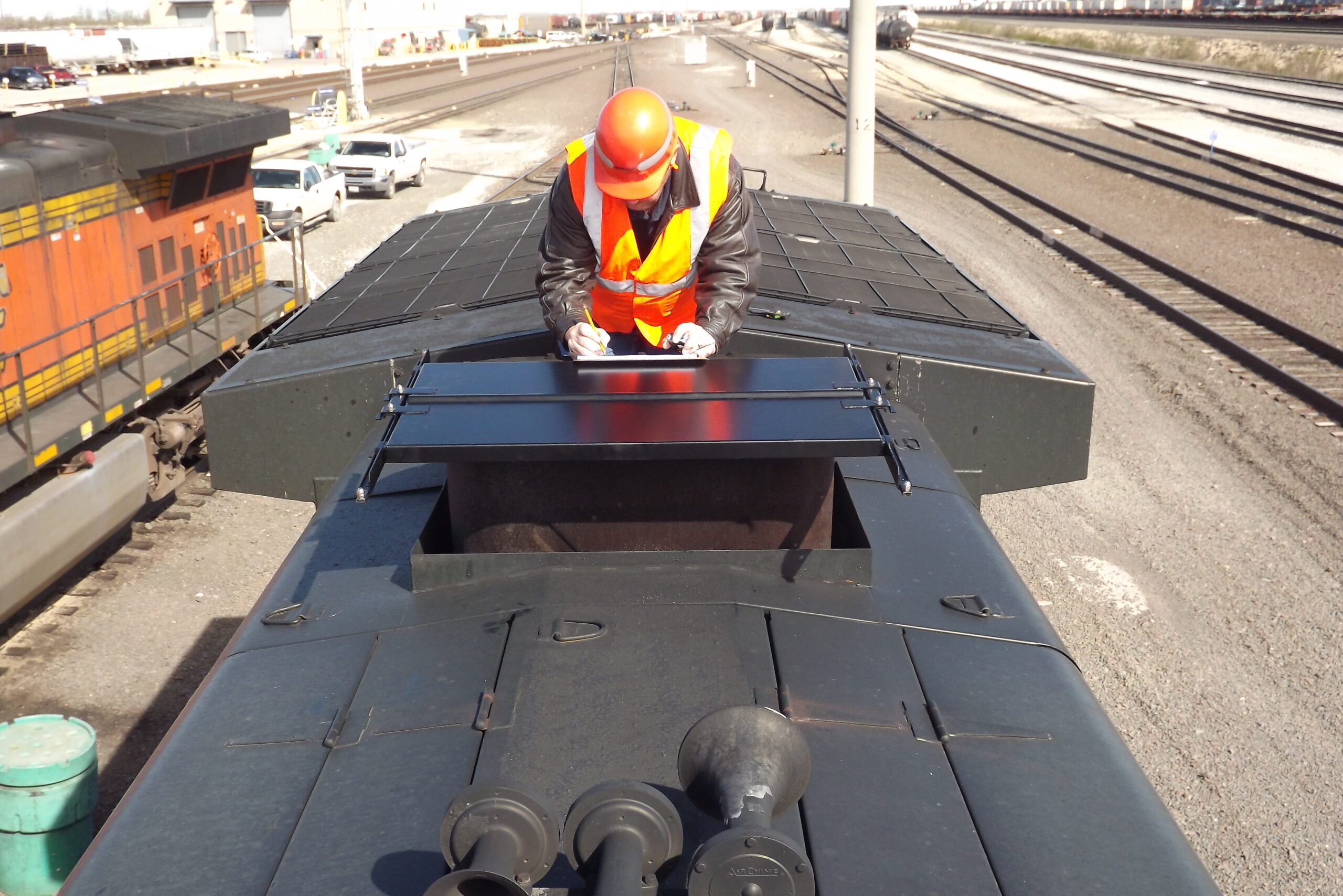 employee installing EMD Turbo Stack Cover: protects the engine from snow and rain during storage of the locomotive