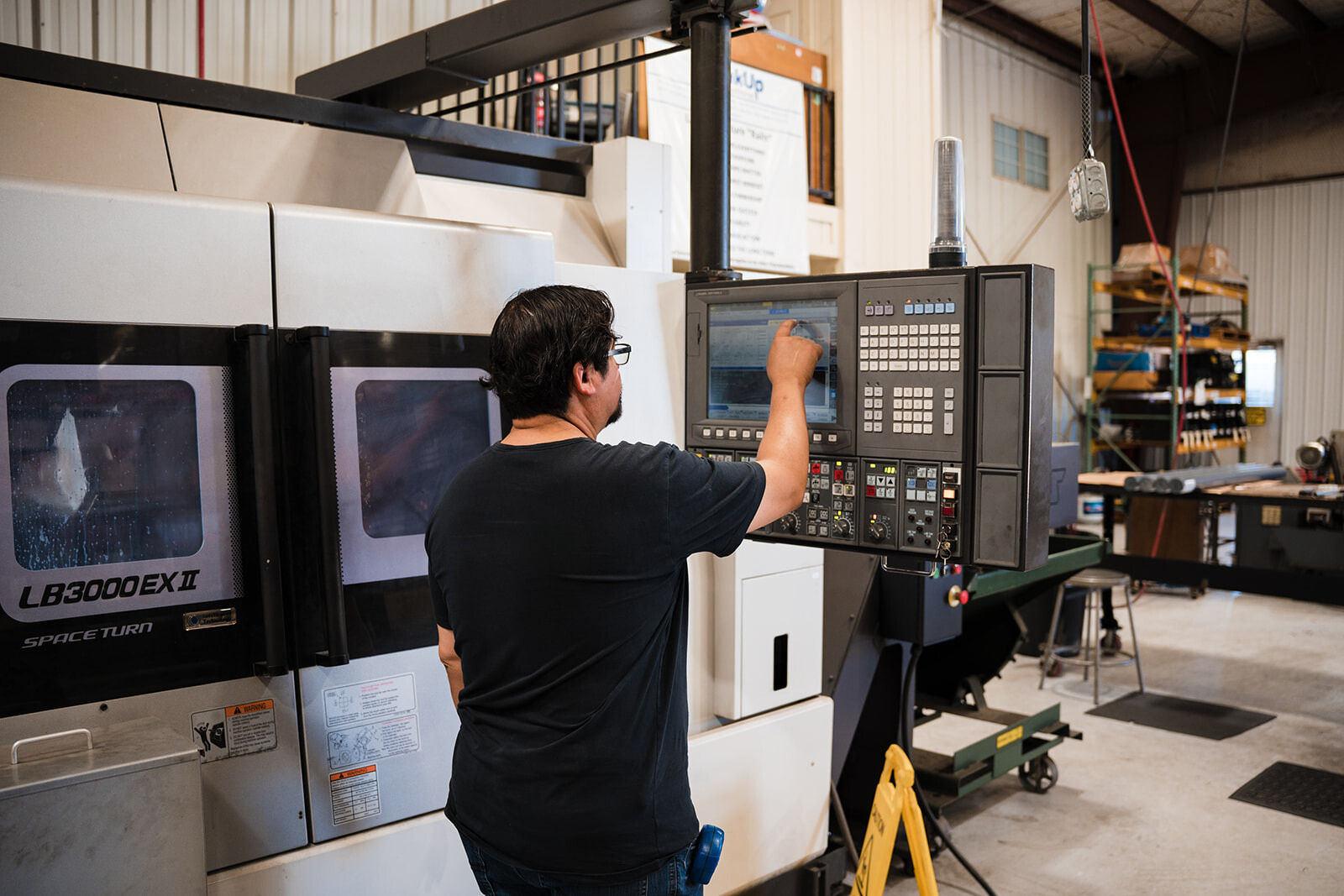cnc lathe machine being used by an employee